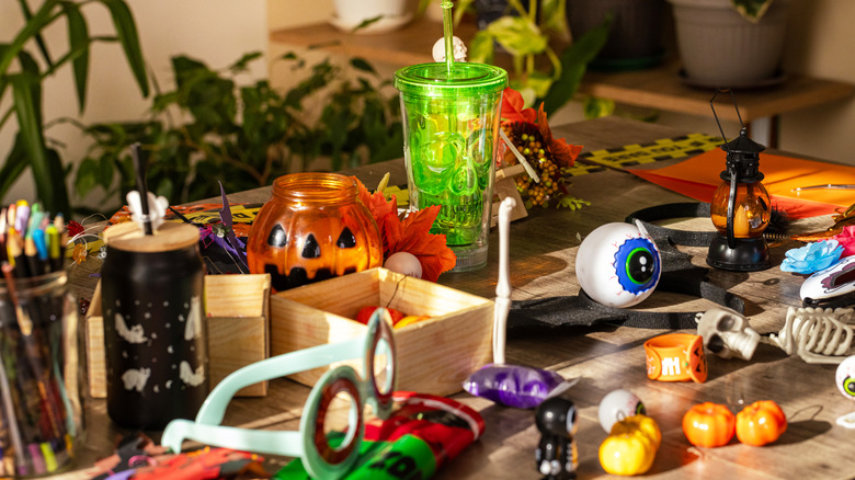Spooky accessories and festive items on a decorated table.