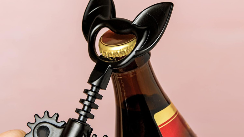 The Ototo Vino Bat Wine Opener opening a beer botttle.