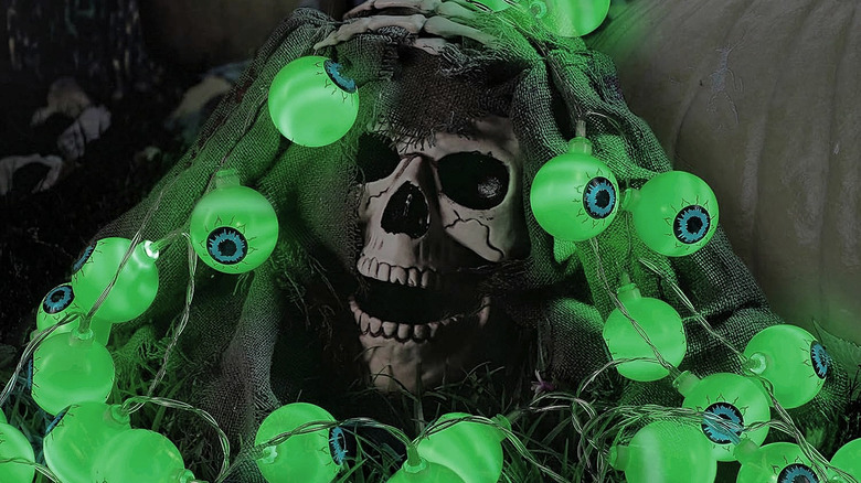 A skull draped with Yunaking Halloween Eyeball String Lights.