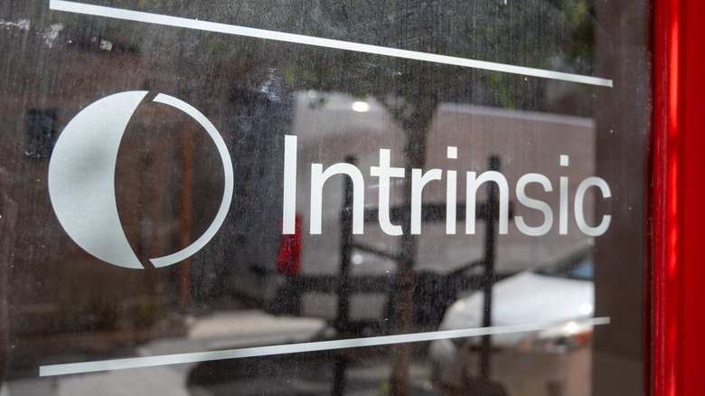 The Intrinsic logo in a building's window.