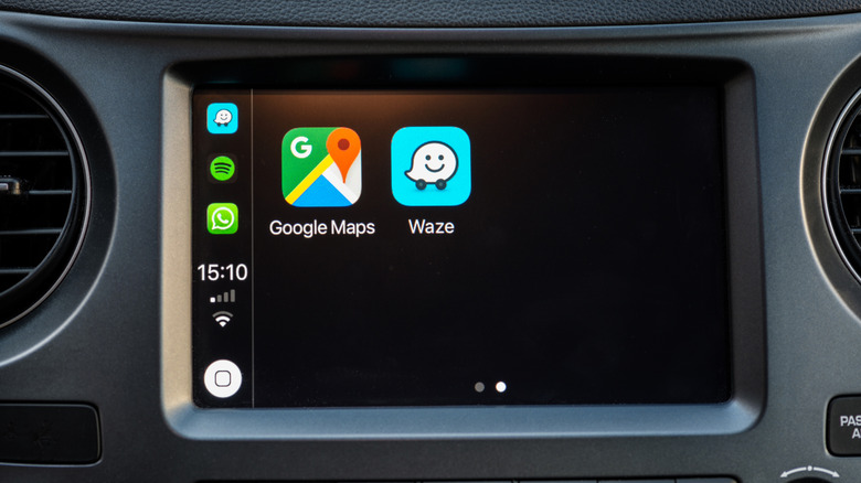 The Waze and Google Maps apps displayed next to each other on a car's dashboard.