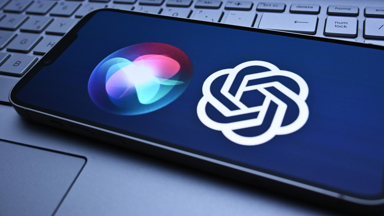 Siri and ChatGPT side by side on iPhone, sitting on laptop keyboard