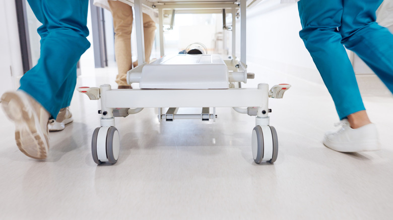 Nurses running with a gurney in a hospital setting