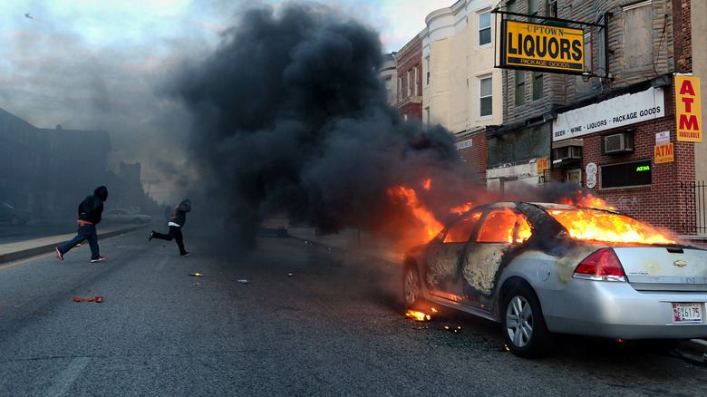 A car on fire on a town street