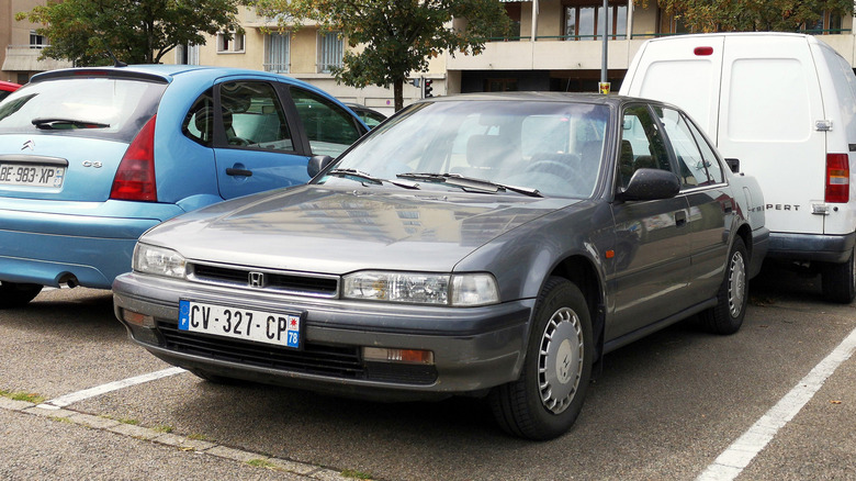 An old Honda Accord in a parking lot