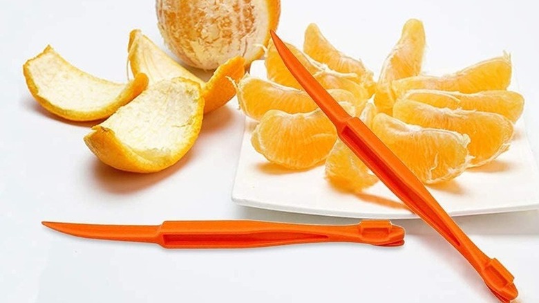 Orange peeler and oranges