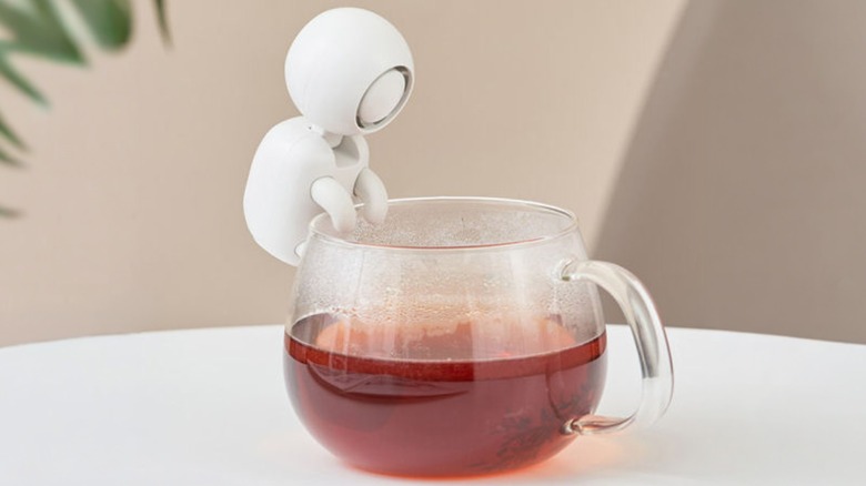 A Life on Cup and Bowl Cooling Fan sitting on a cup of tea