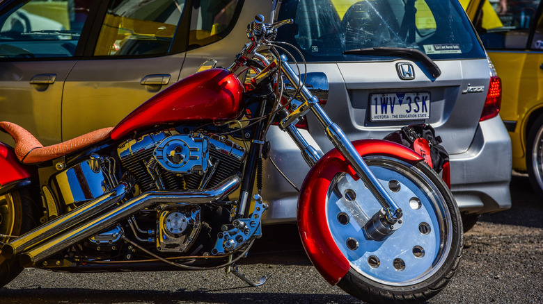 A custom Harley-Davidson Low Rider bike in red on display at a bike show in Australia.