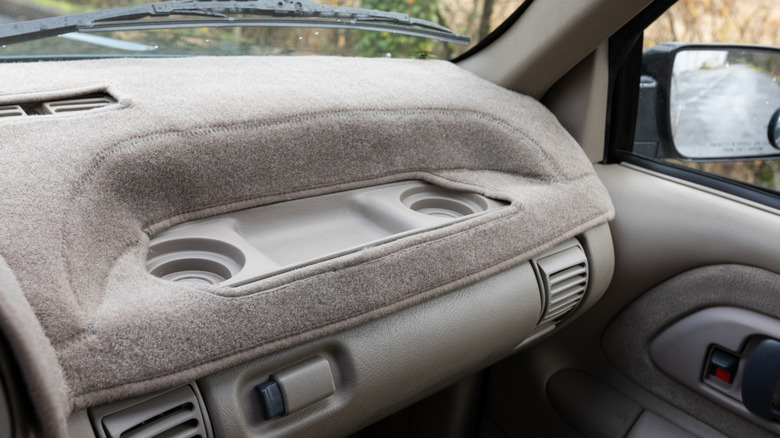 A dashboard cover being used in a car