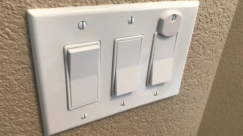 Three rocker switches with one held to the off position