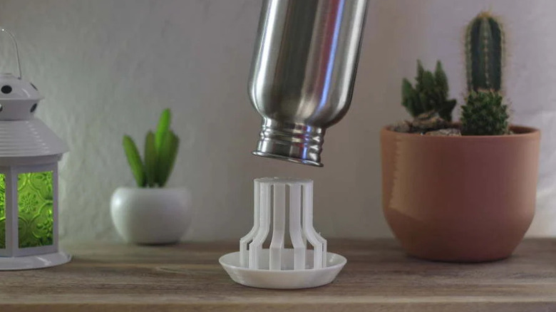 Metal bottle over a water bottle drying stand