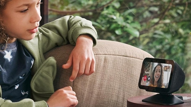 A child uses an Amazon Echo to video call family or friends.