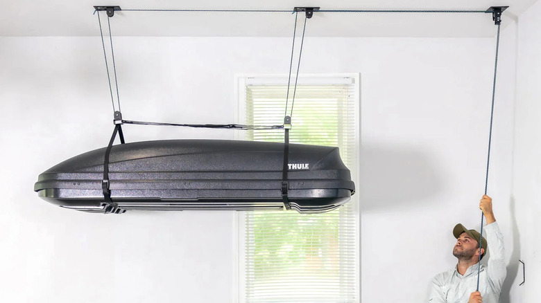 Store Your Board ceiling hoist being lifted b a person