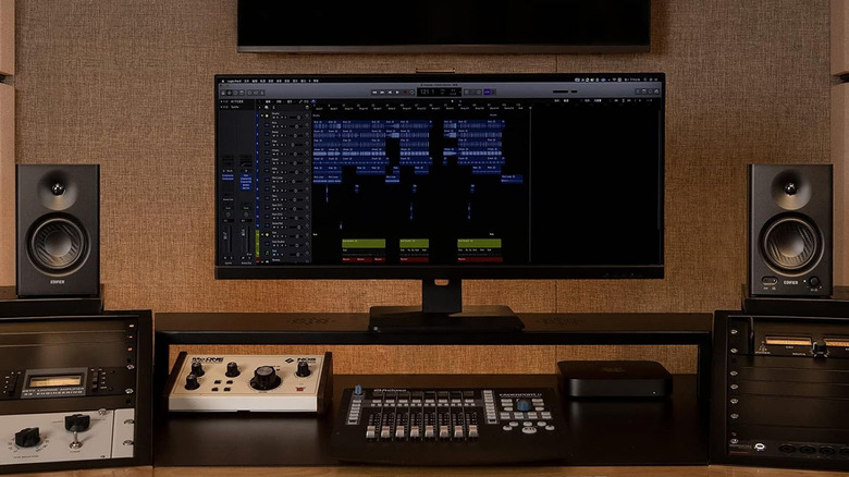 Two Edifier MR4 speakers flanking a large computer monitor and music setup.