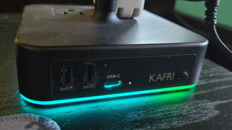 A Kafri Headphone Stand on a black desk.