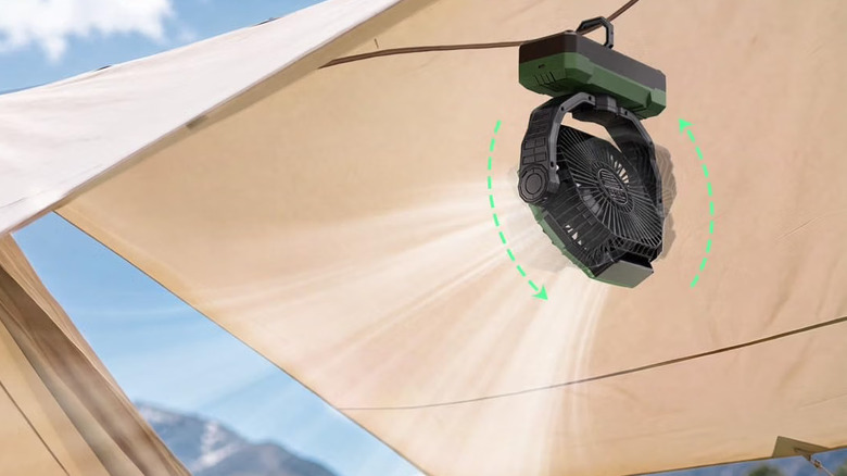 Frizcol 3-in-1 camping fan being held up by the hook as it blows air downward