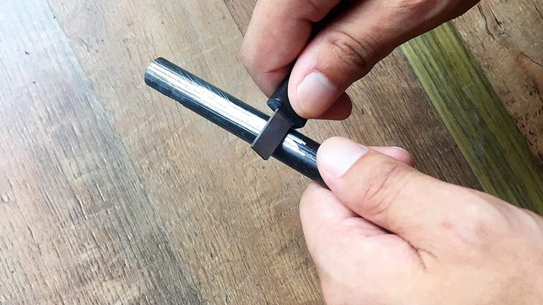 Ferro rod and striker being used to create a series of sparks