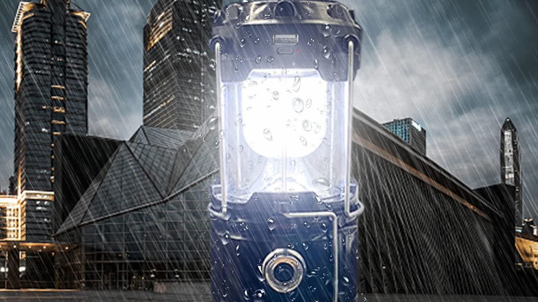 Portable LED Xtauto lantern with a city background while it rains