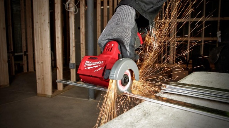 Using a cut off wheel to cut steel rods.