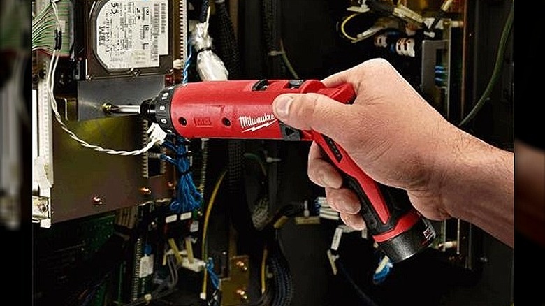 Using a hex screwdriver on an electrical board.