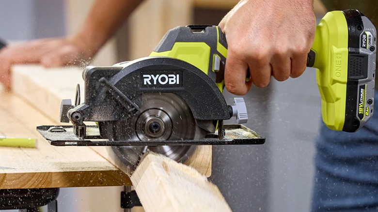 Cutting a wooden board with Ryobi 4-1/2 Inch Circular Saw.