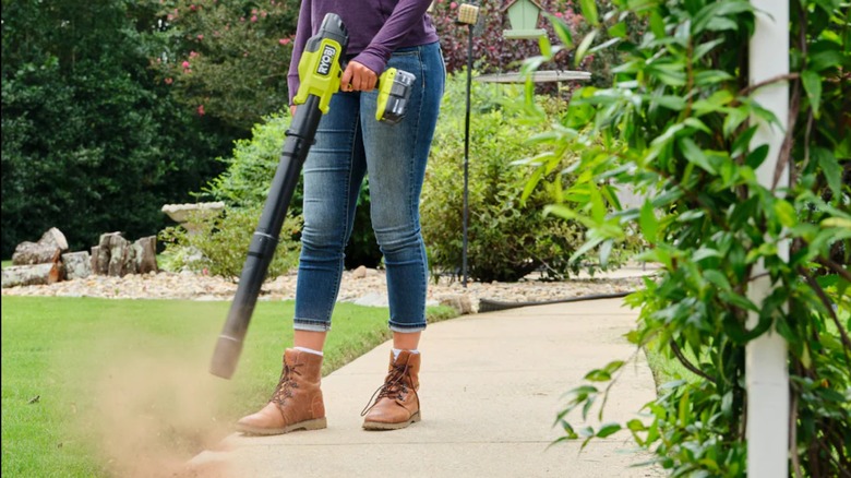 Blowing away debris from path with Ryobi Compact Brushless Blower.