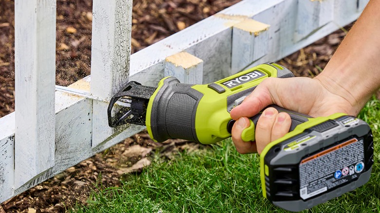Cutting fencing boards with Ryobi one-handed reciprocating saw.