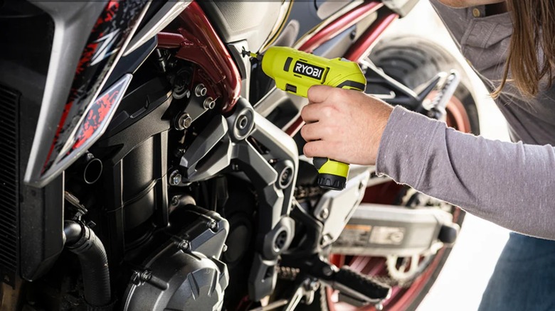 installing components on a motorcycle with Ryobi screwdriver