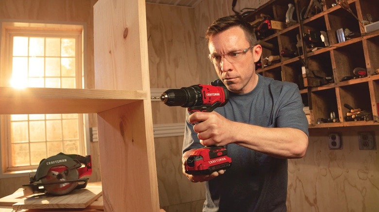 Person using Craftsman power drill