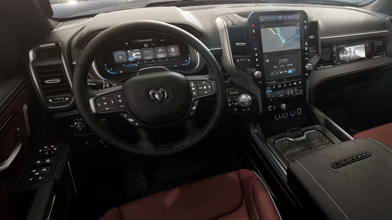 The burgundy interior of the 2026 RAM 1500, photographed from above the driver's left shoulder.