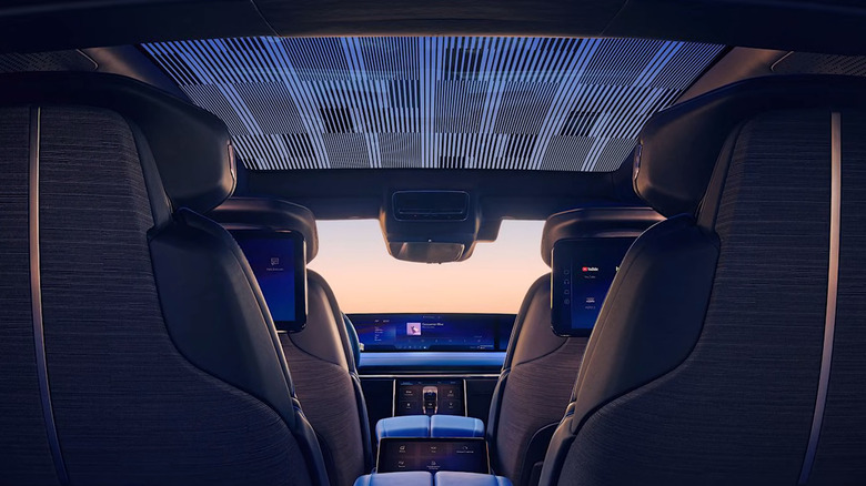 The interior of the 2026 Cadillac Celestiq as seen from behind the second row of seats and their built-in screens