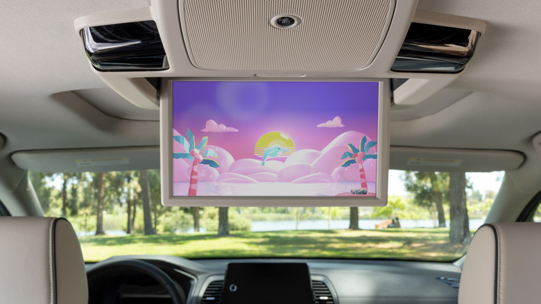 The interior of the 2026 Honda Odyssey as seen from the second row, showcasing its top-mounted rear display screen