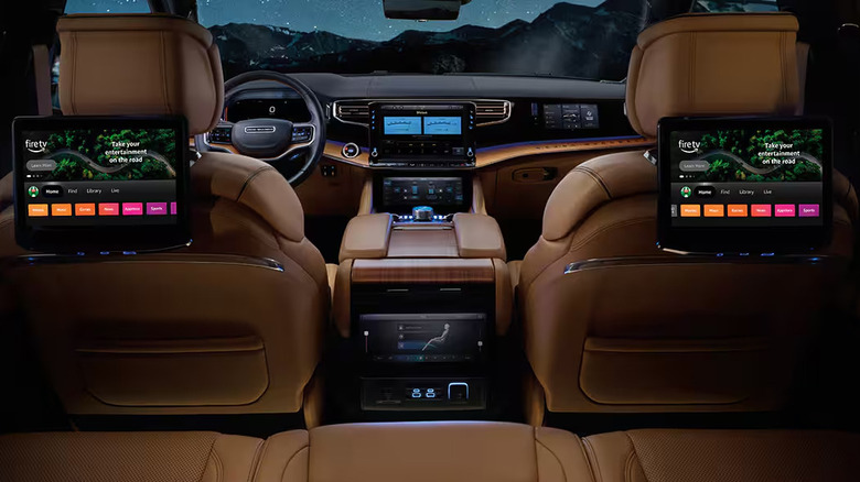 The interior of the 2026 Jeep Grand Wagoneer from the second row of seats, showcasing the rear screens
