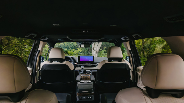 The interior of the 2026 Toyota Sienna as seen from the third row of seats, its single rear screen stowed away