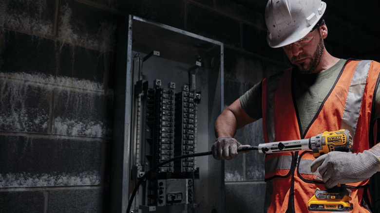 Worker using a DeWalt cable stripper