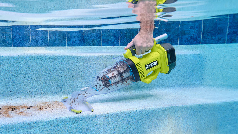 Ryobi's pool vacuum cleaning up debris