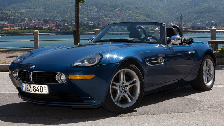 A blue BMW E52 Z8 Roadster parked near a lake.