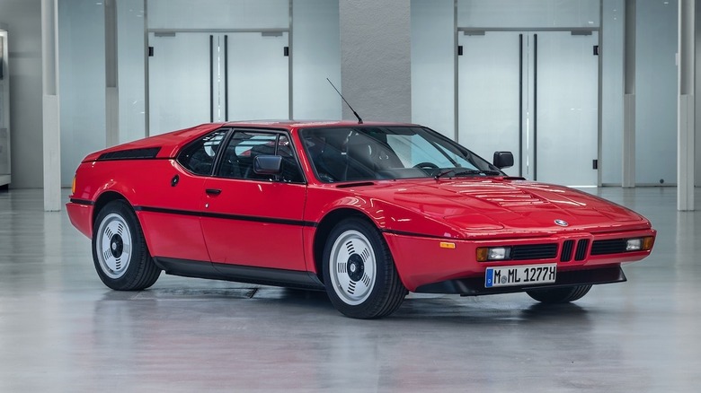 A red BMW M1 inside a building.