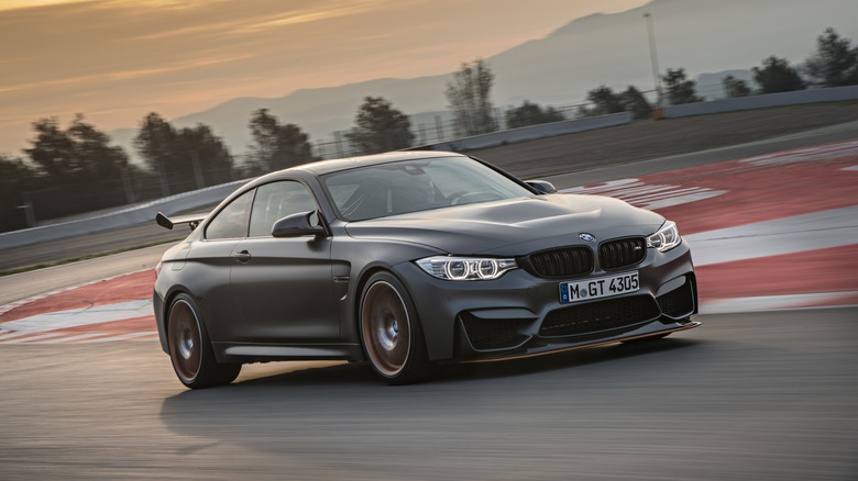 A gray BMW M4 GTS on a racing track.