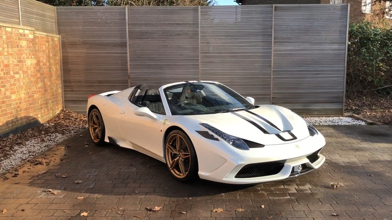 A white Ferrari 458 Speciale Aperta parked