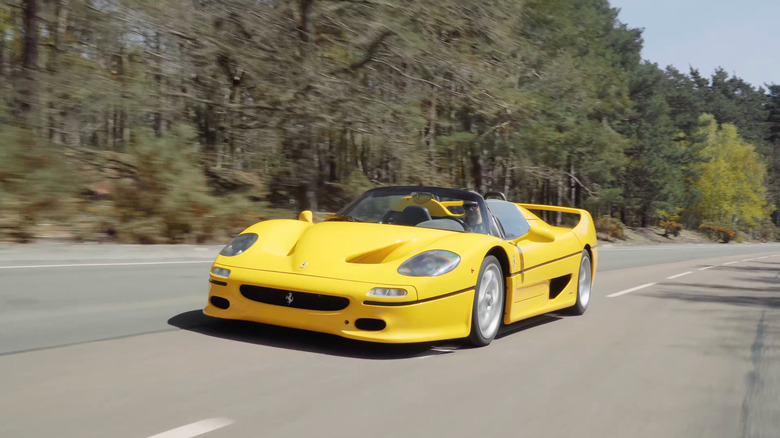 A yellow Ferrari F50 driving