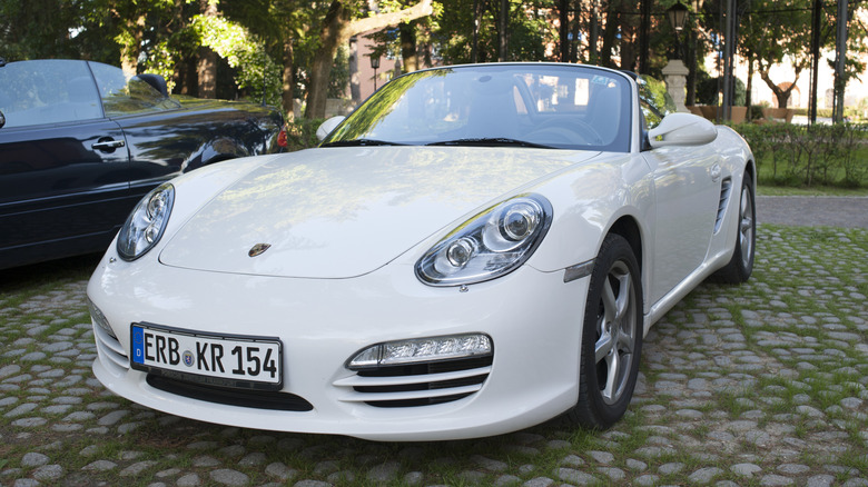 A front end shot of a White 2012 Porsche Boxster parked