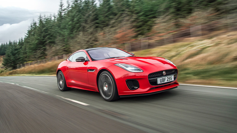 A front end shot of a red 2018 Jaguar F-Type driving