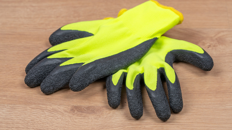 A pair of protective gloves on a wooden table