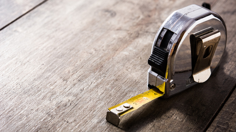 A tape measure on a wooden table