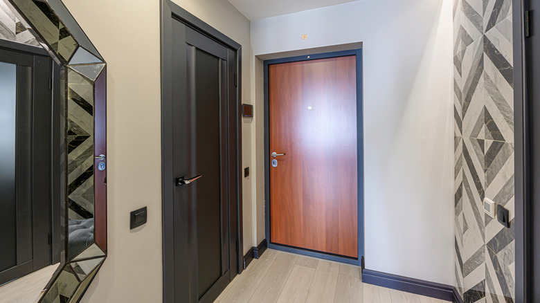 Room featuring sleek doors and wall designs