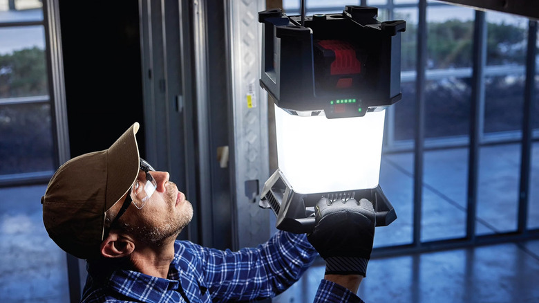 Worker hanging up the area light onto a hook
