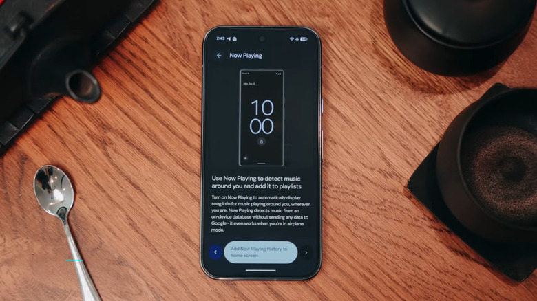 Now  Playing feature on a Google Pixel phone lying on a wooden table.