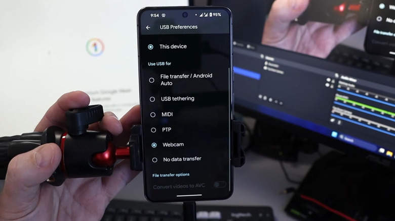 A Google Pixel set to webcam mode in front of a computer.