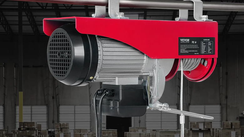 Vevor 440 lb Electric Garage Hoist with warehouse background
